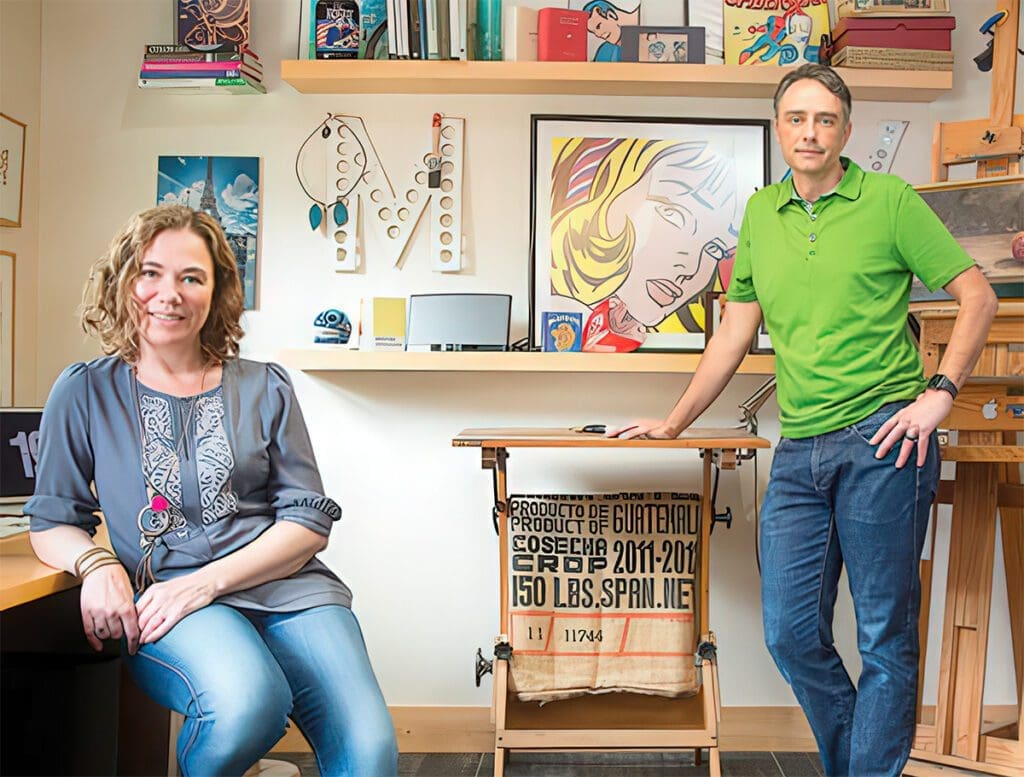 Hand-illustrated wedding invitation designers Michael and Yvette in their creative studio workspace